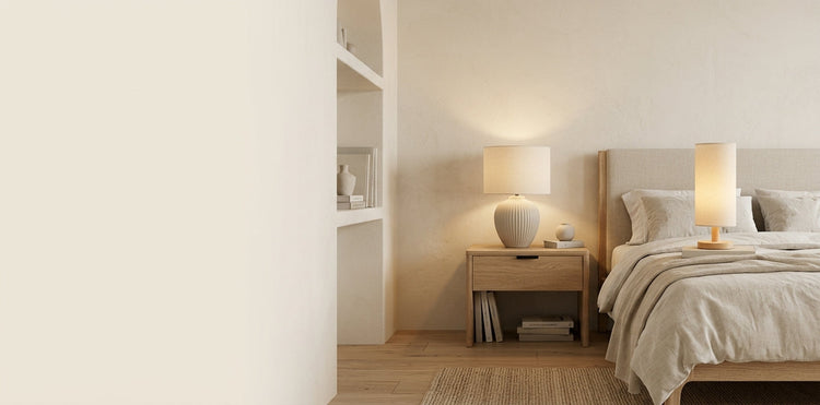 Ceramic table lamp glowing on a wooden console