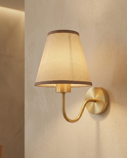 Brass E27 wall lamp with tan fabric shade in a hallway